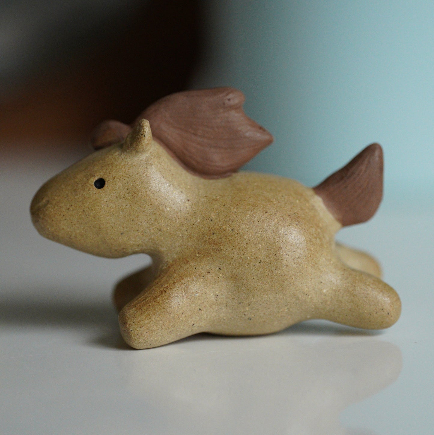 Small ceramic horse on blurred background