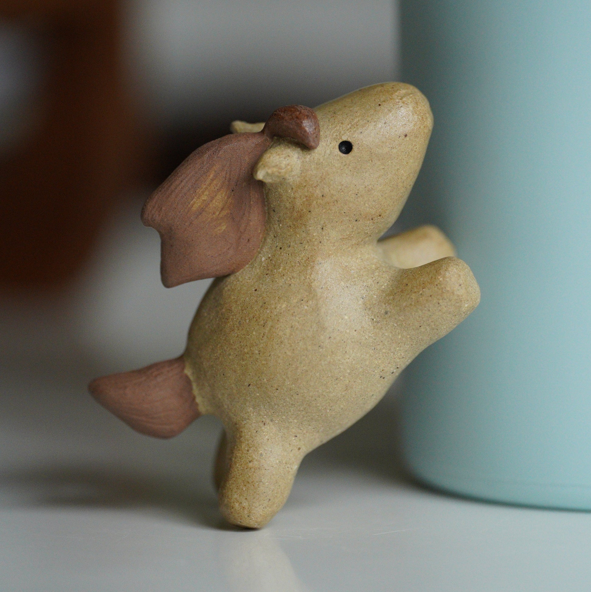 Small ceramic horse leaning on water bottle